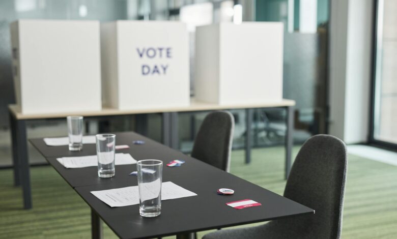 Person casting ballot in private voting booth during election