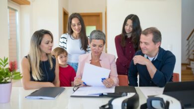 Professional family meeting around conference table discussing important documents and planning