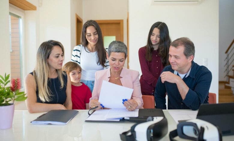 Professional family meeting around conference table discussing important documents and planning