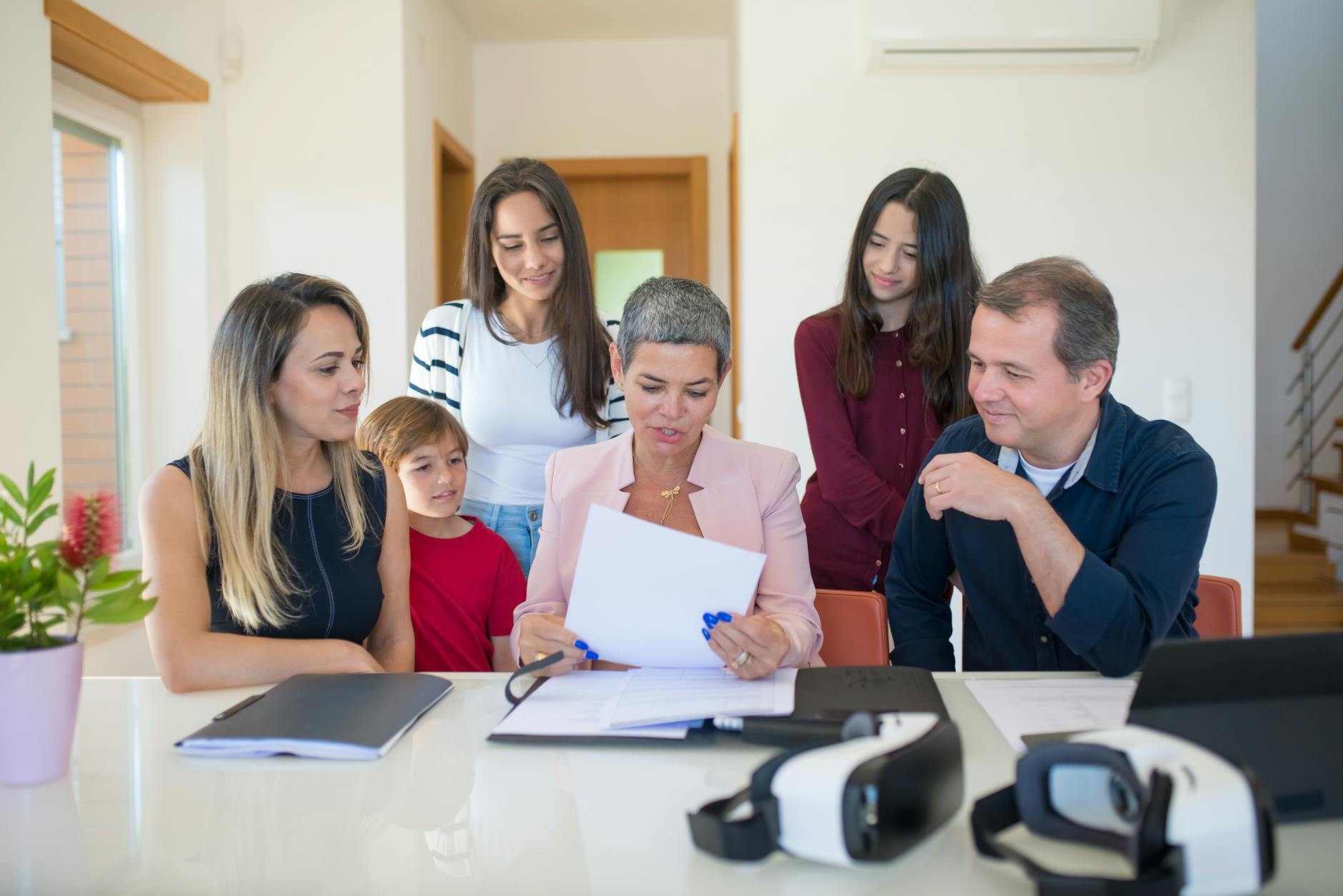 Professional family meeting around conference table discussing important documents and planning