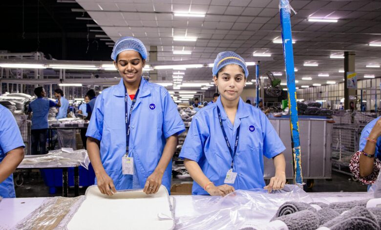 Industrial workers in manufacturing facility wearing safety equipment