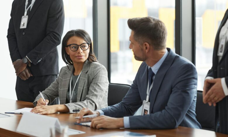 Professional business meeting with documents and charts on table