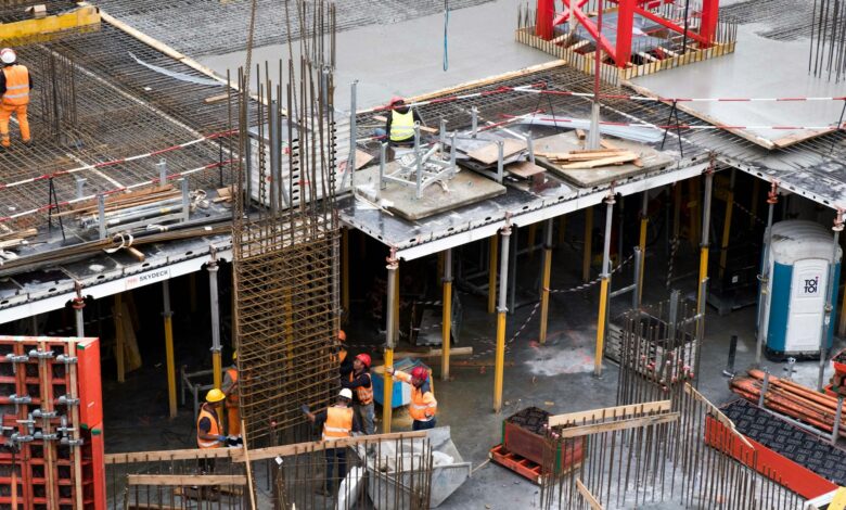 Construction workers and equipment at an infrastructure development site