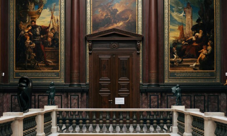 Modern art museum gallery with paintings displayed on white walls under professional lighting