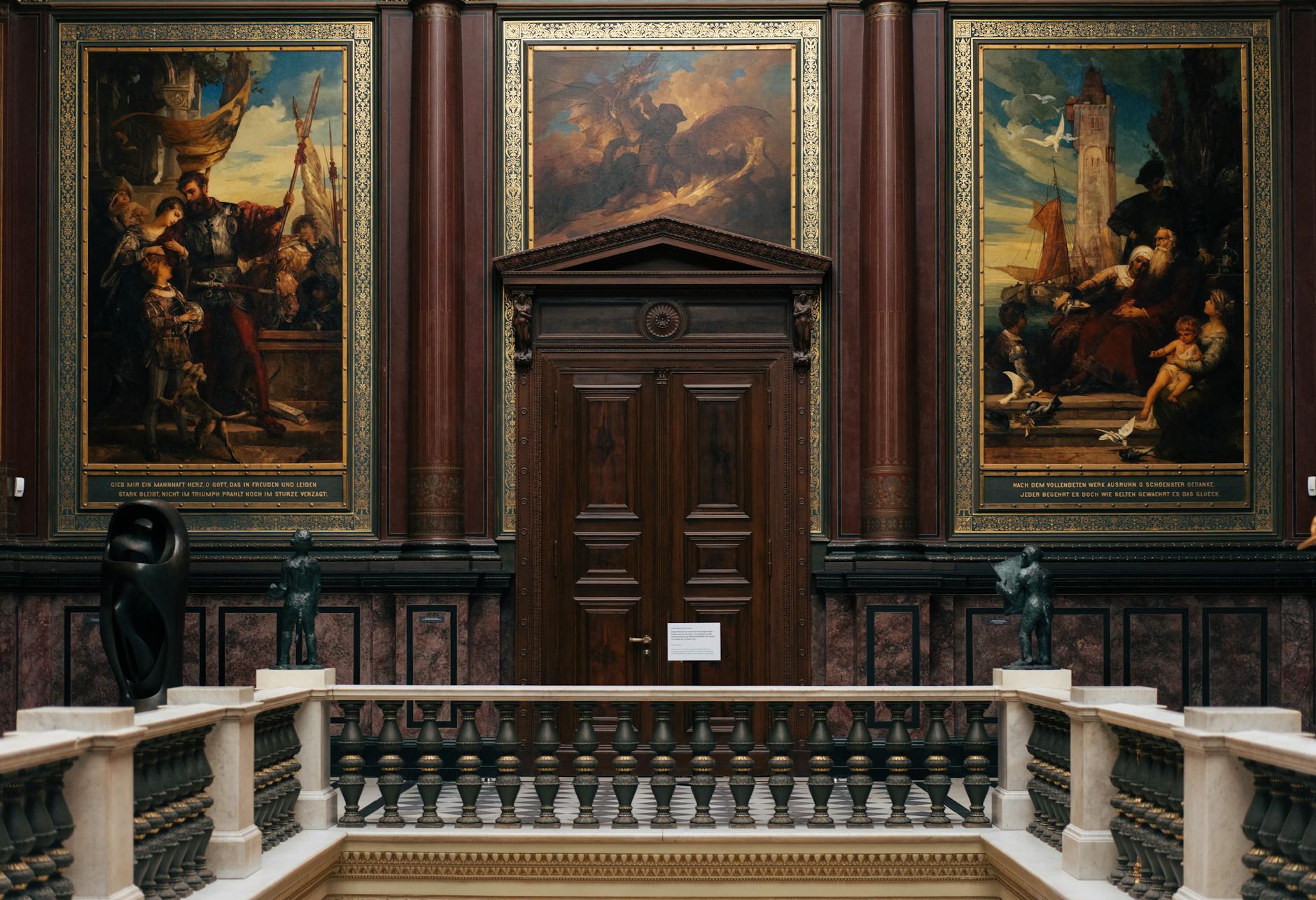 Modern art museum gallery with paintings displayed on white walls under professional lighting