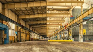 Large industrial warehouse interior with stacked materials and storage systems