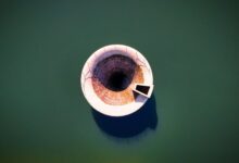 Aerial view of a large water reservoir with concrete dam structure