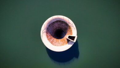 Aerial view of a large water reservoir with concrete dam structure