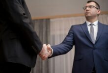 Professional business meeting with handshake representing wealth planning discussions