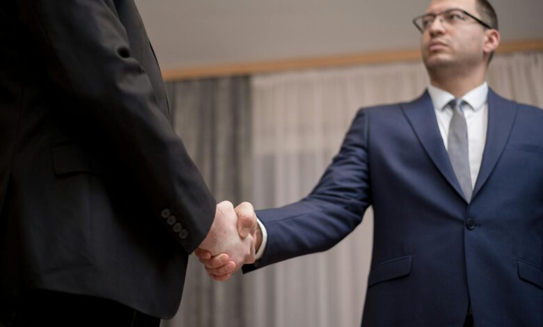 Professional business meeting with handshake representing wealth planning discussions