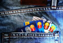 Credit cards arranged with digital wallet showing cryptocurrency transactions