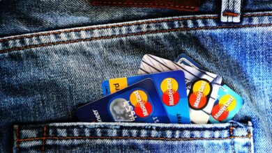 Credit cards arranged with digital wallet showing cryptocurrency transactions