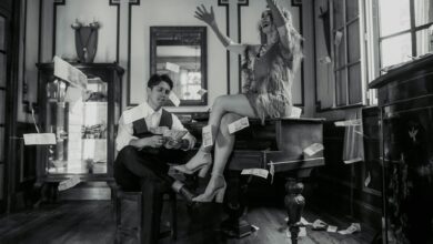 Aerial view of a modern sports stadium with surrounding cityscape