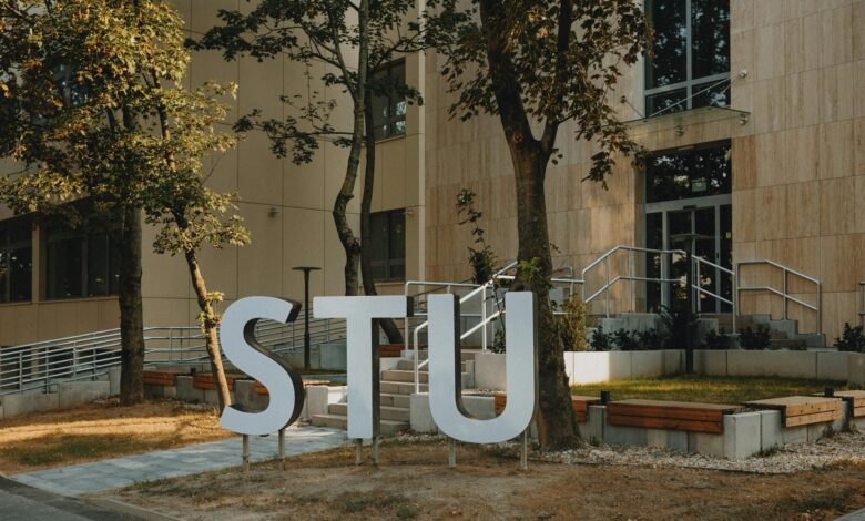 Students walking across university campus quad with academic buildings in background