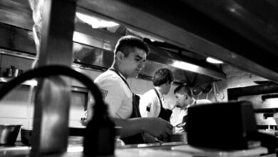 Busy restaurant kitchen with multiple chefs working during peak hours