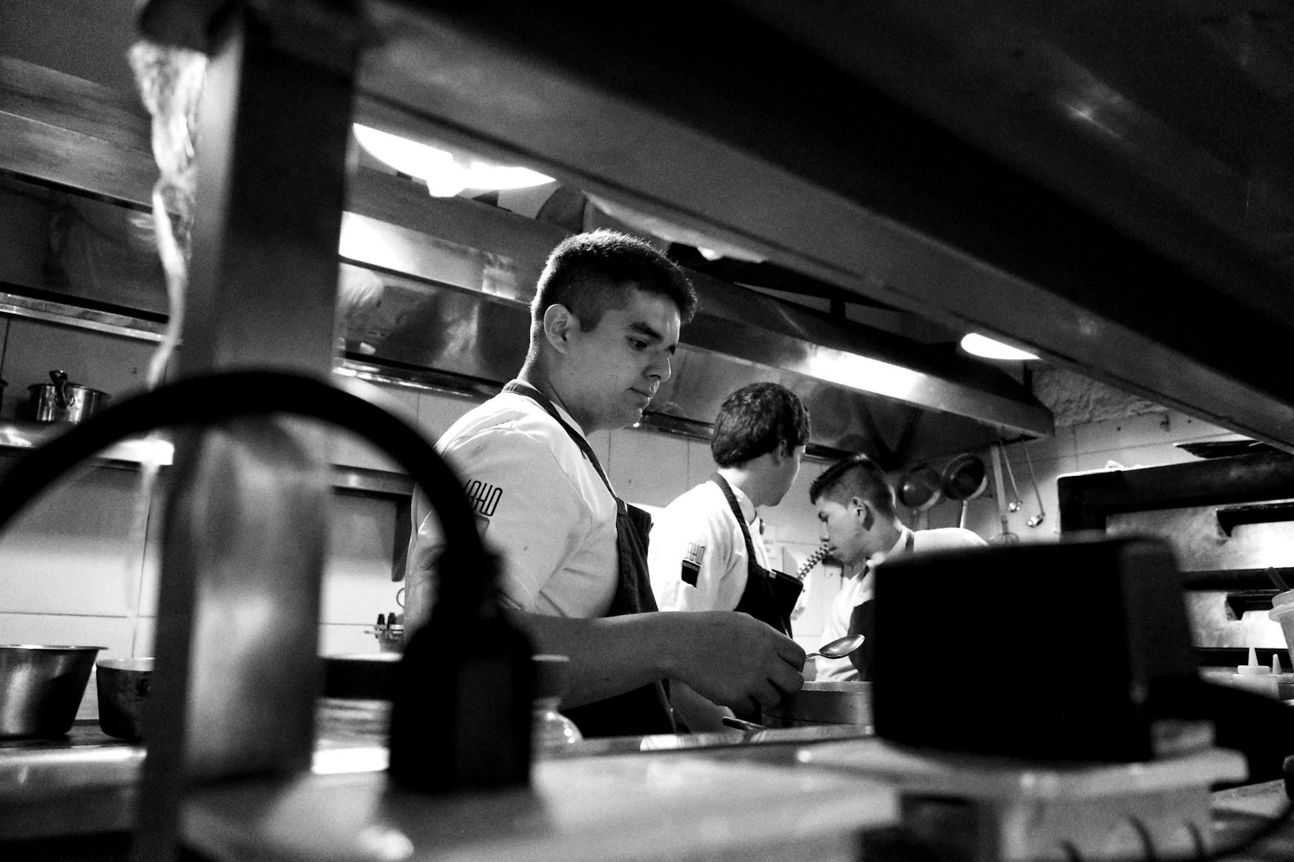 Busy restaurant kitchen with multiple chefs working during peak hours