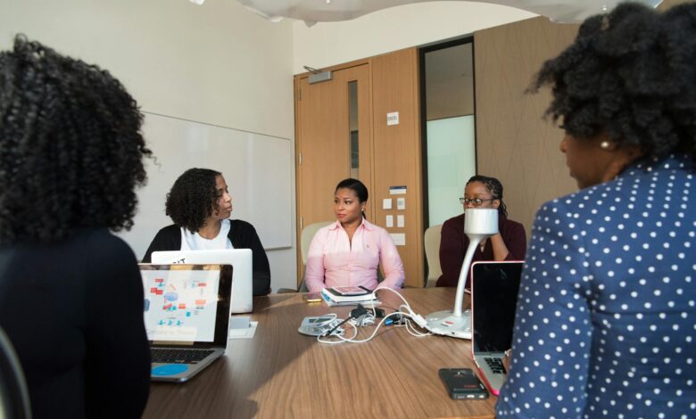 Business professionals discussing investment strategies around conference table