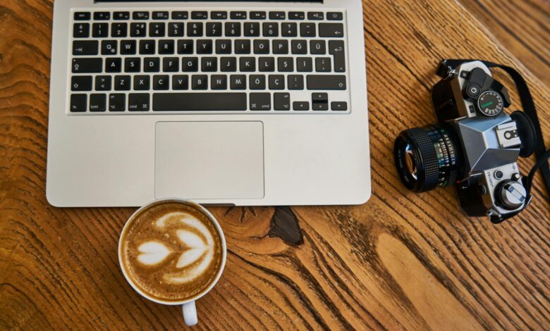 Person working on laptop with coffee cup, representing remote side hustle work