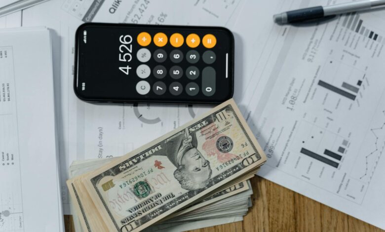 Calculator and money showing financial calculations for investment returns