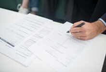 Business insurance documents and paperwork spread across a desk