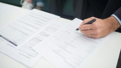 Business insurance documents and paperwork spread across a desk