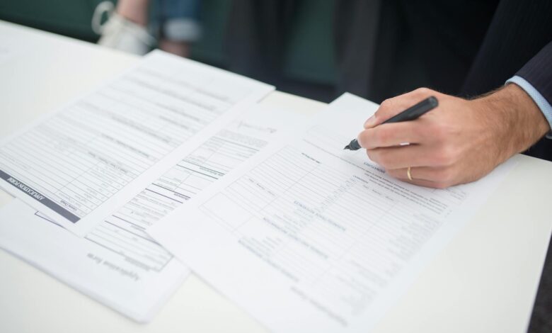 Business insurance documents and paperwork spread across a desk