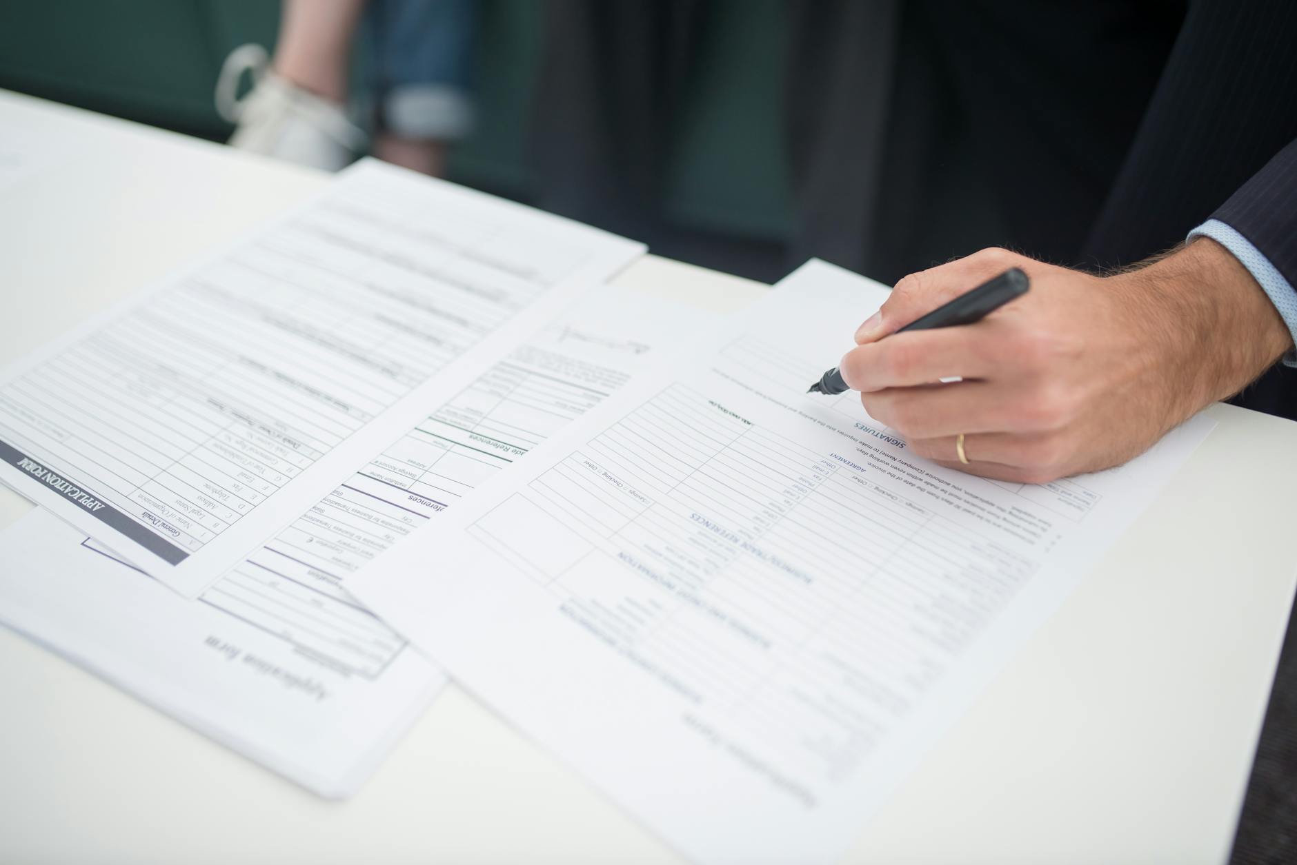 Business insurance documents and paperwork spread across a desk
