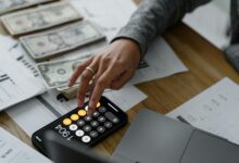 Financial calculator and planning documents on desk representing retirement calculations