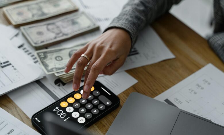 Financial calculator and planning documents on desk representing retirement calculations