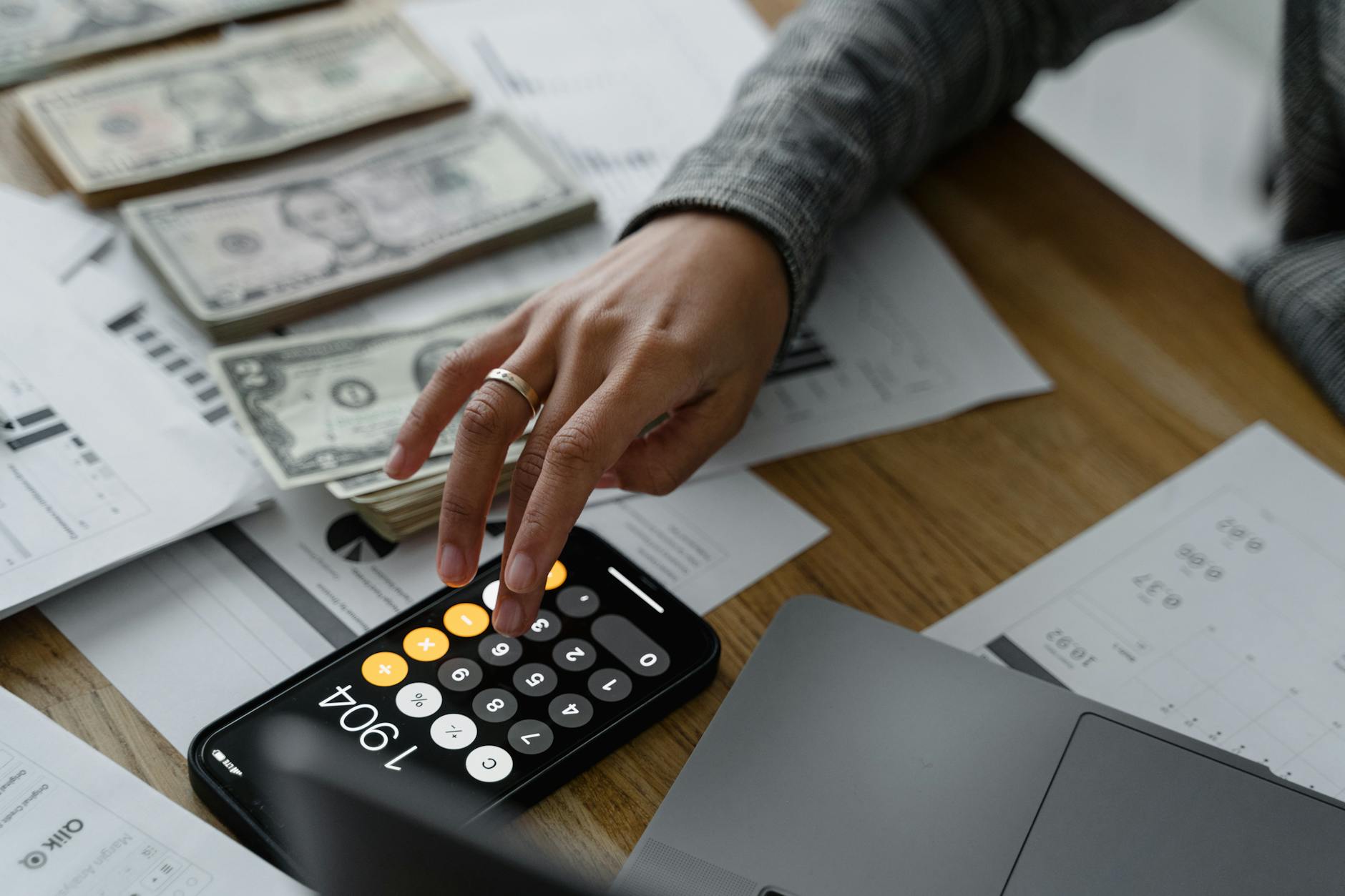 Financial calculator and planning documents on desk representing retirement calculations