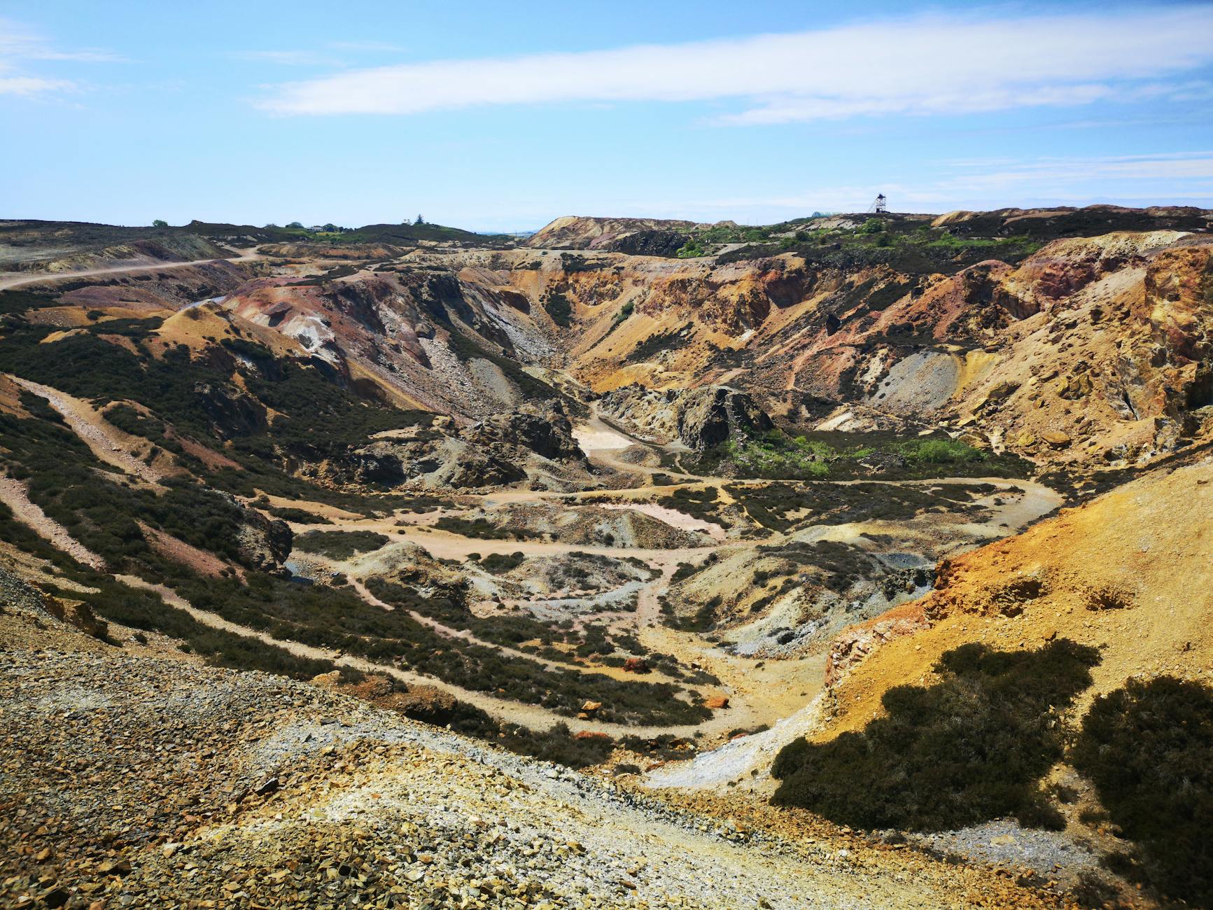 Open-pit copper mine operation showing industrial mining equipment and terraced excavation