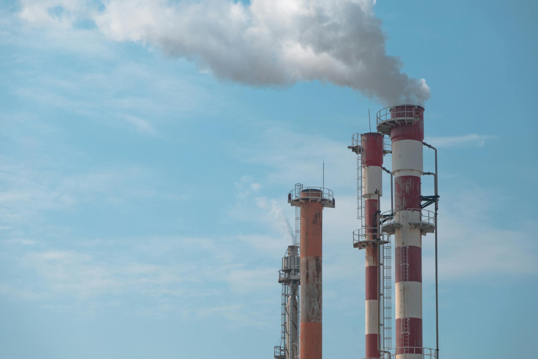 Industrial facility with smokestacks symbolizing environmental regulations debate