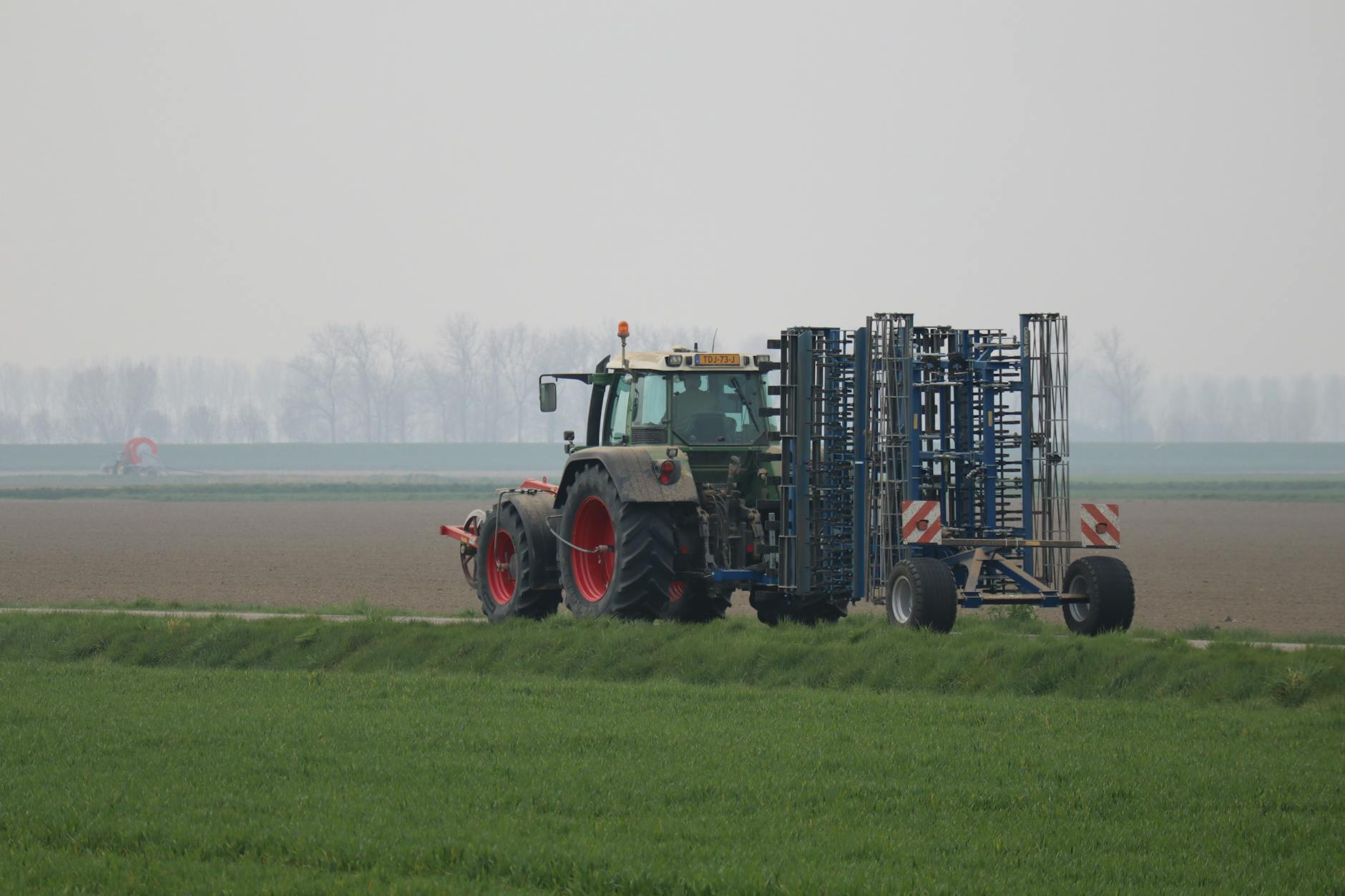 Modern agricultural harvesting machinery operating in crop fields