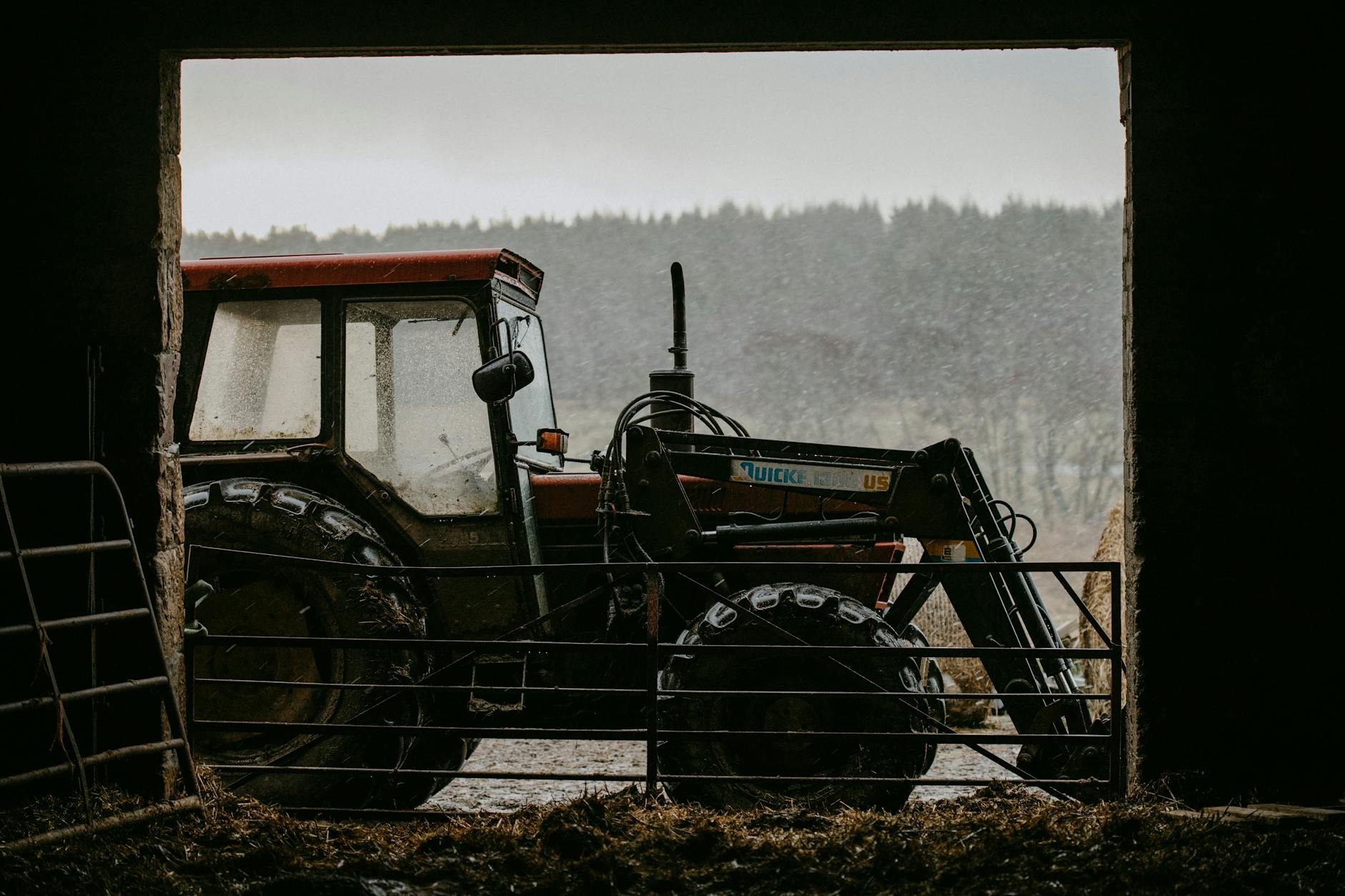 Modern farming tractor working in agricultural field during planting or harvest season