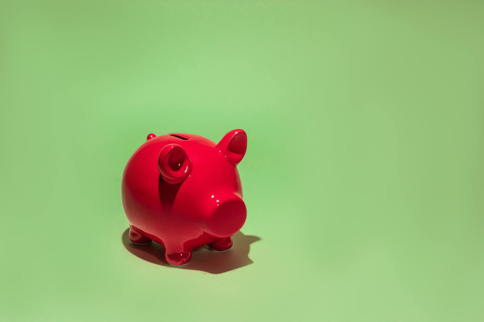Piggy bank with coins and calculator representing retirement savings and investment planning