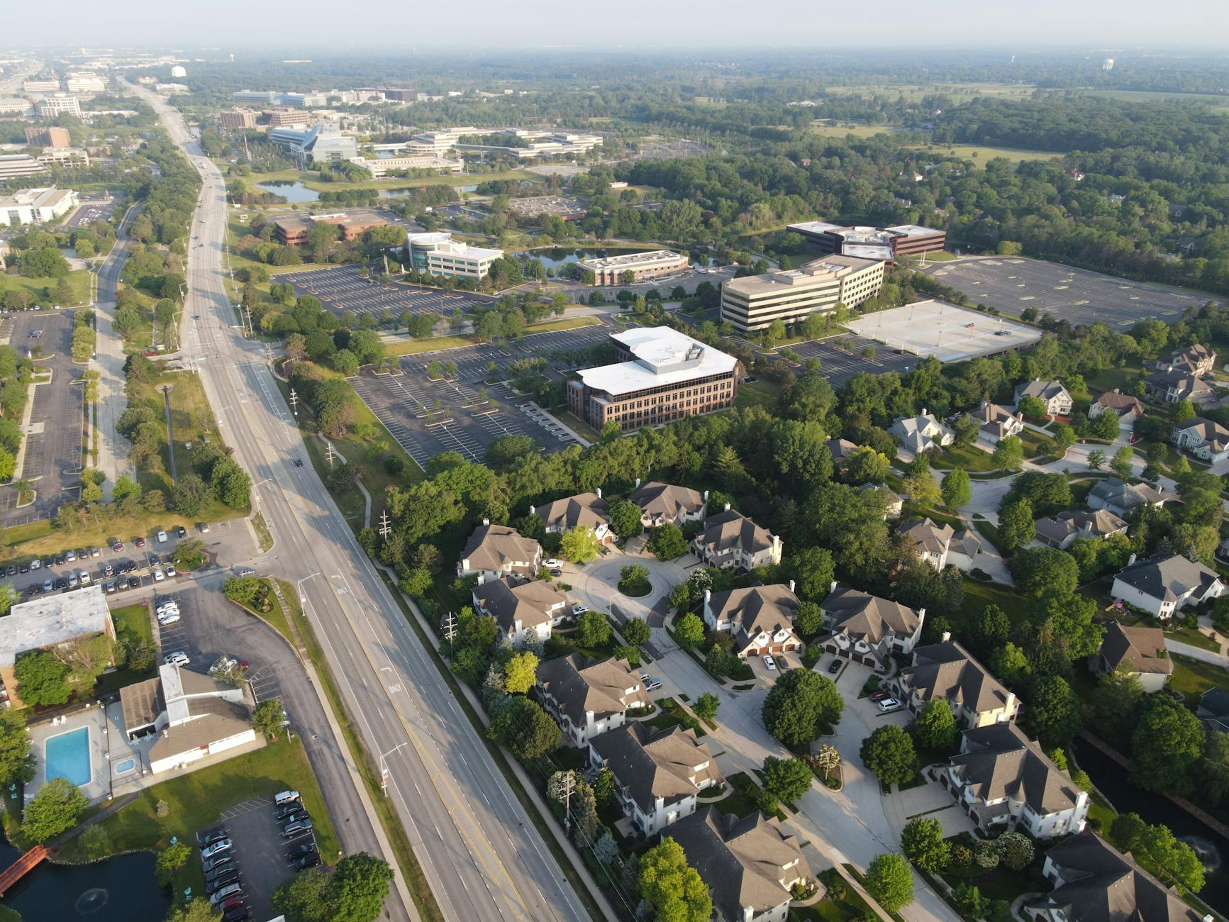 Low-rise suburban office buildings with parking areas and landscaping