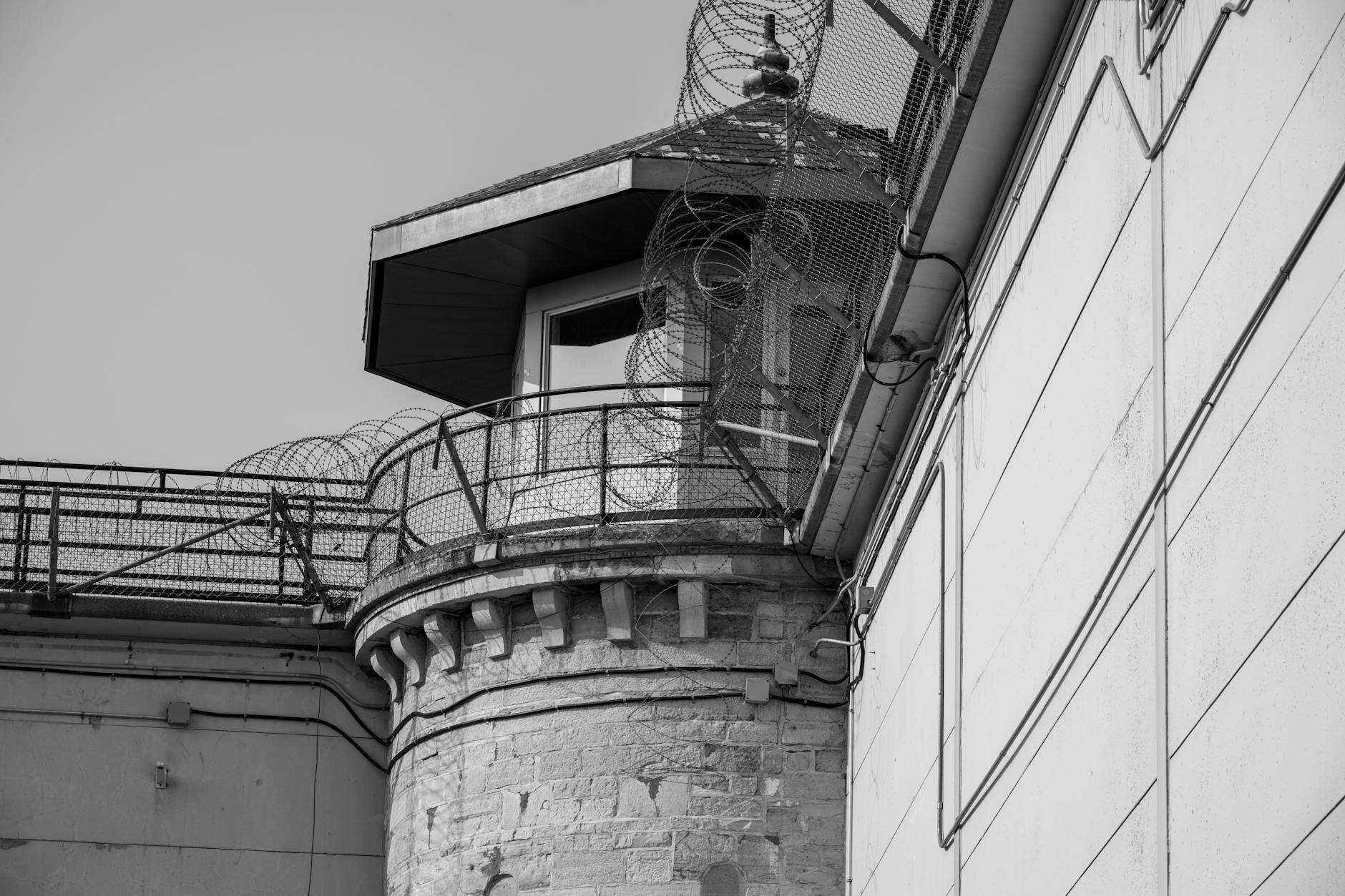Prison facility fence and security infrastructure representing correctional institutions