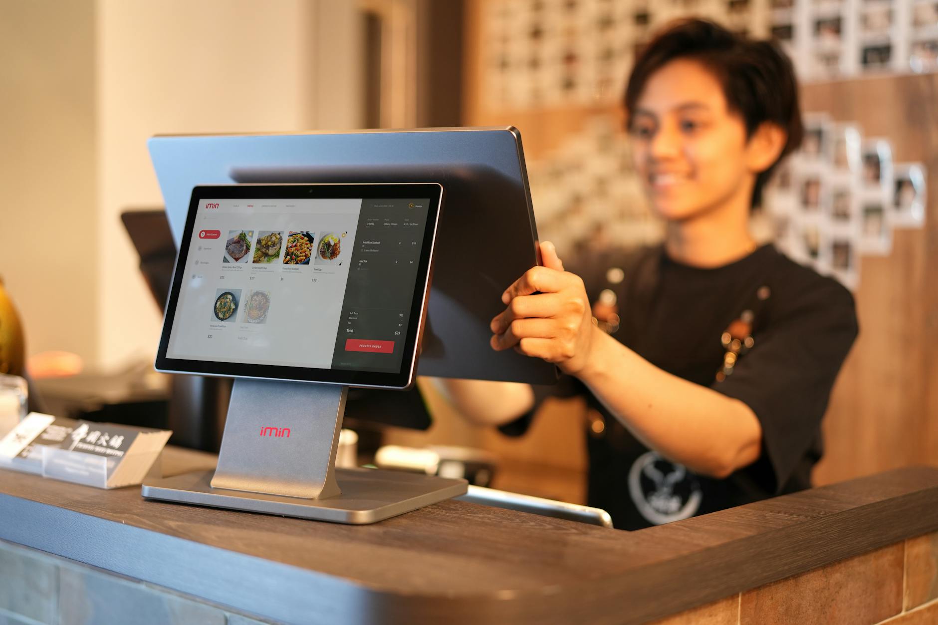 Restaurant manager using tablet to manage digital orders and operations