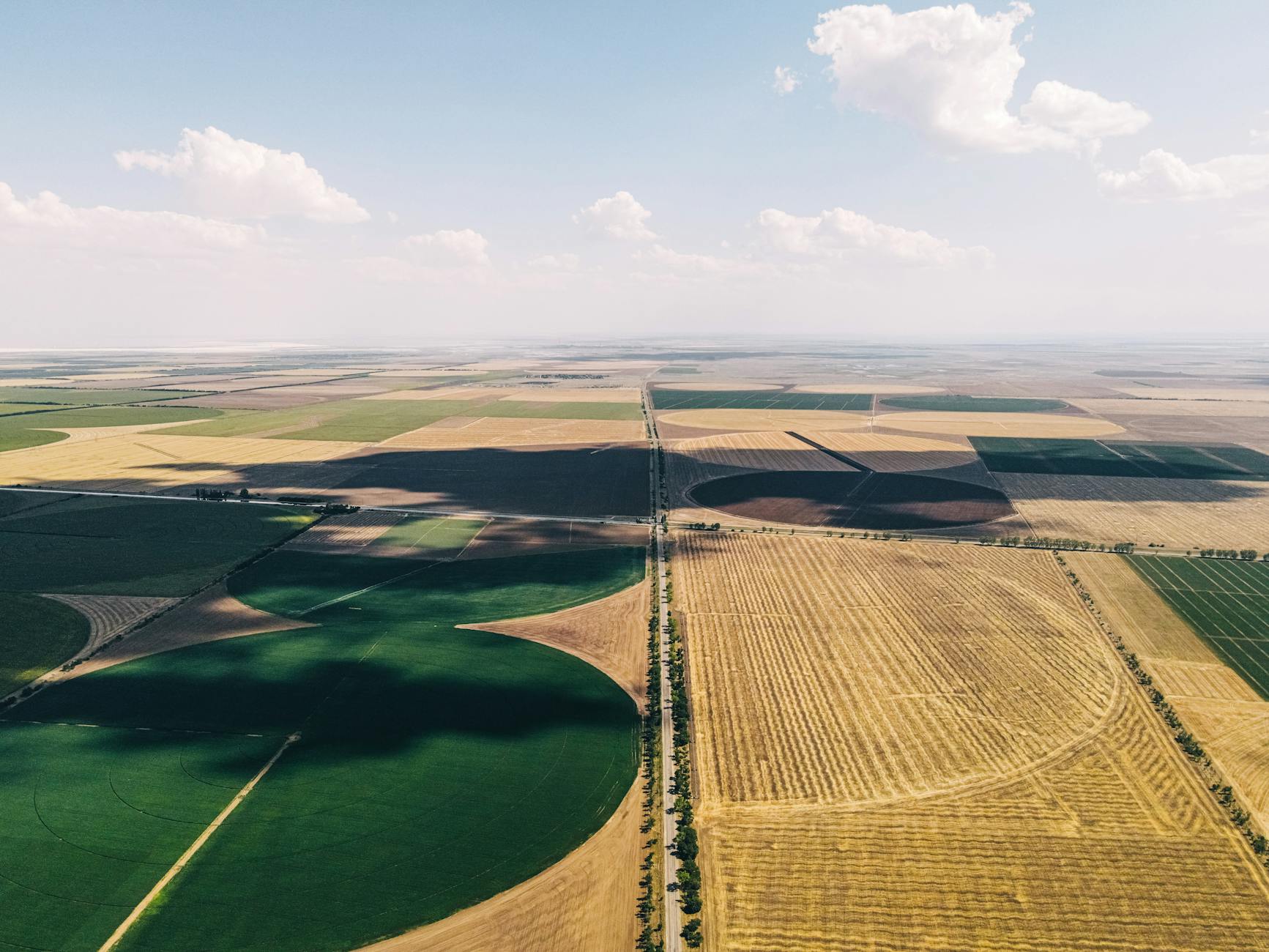 Aerial view of rural farmland and small town, showing the geographic scope of rural credit desert challenges