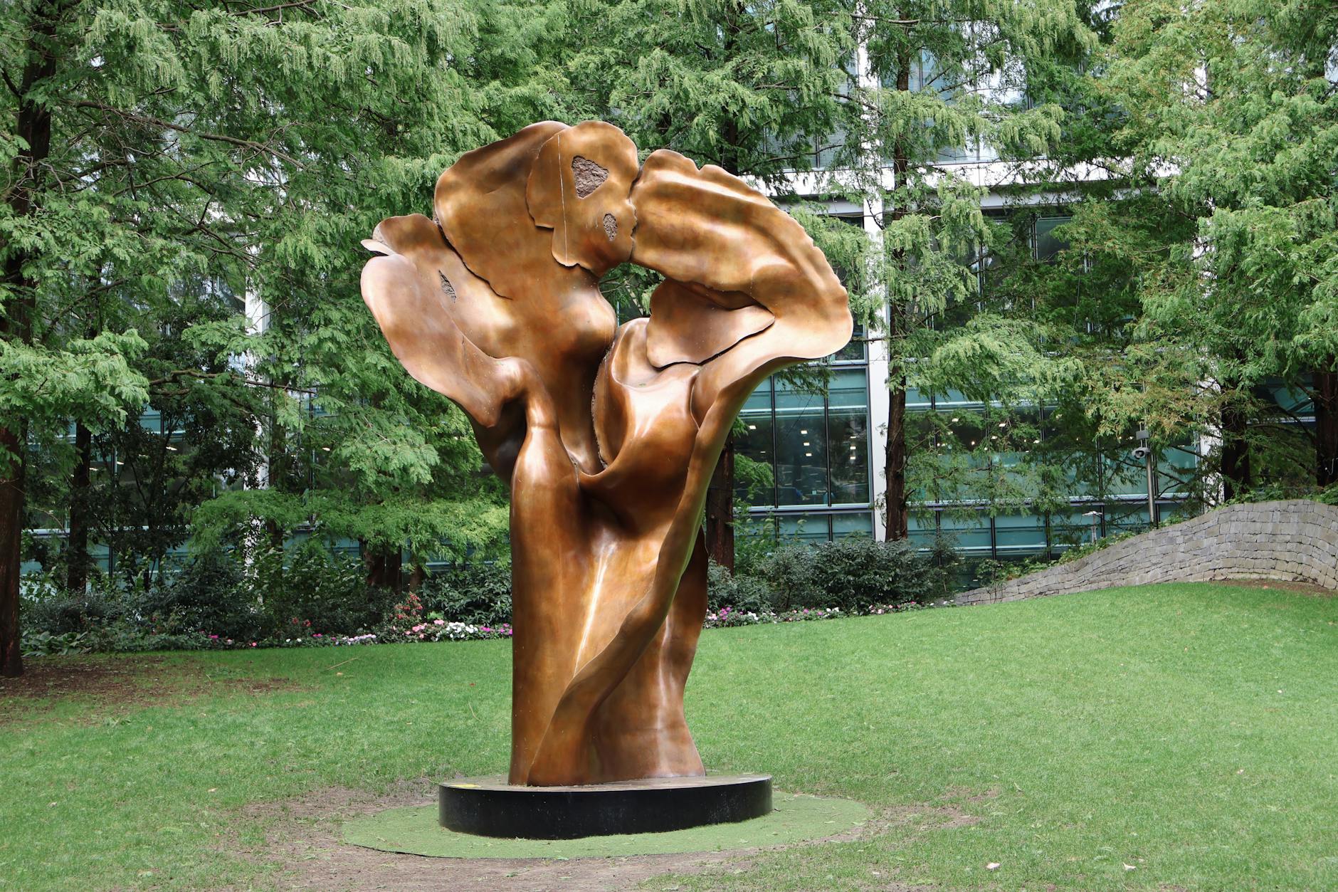 Outdoor sculpture garden with contemporary art pieces displayed among landscaped grounds