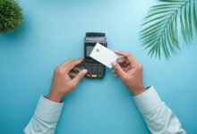 Person using credit card at payment terminal in retail store