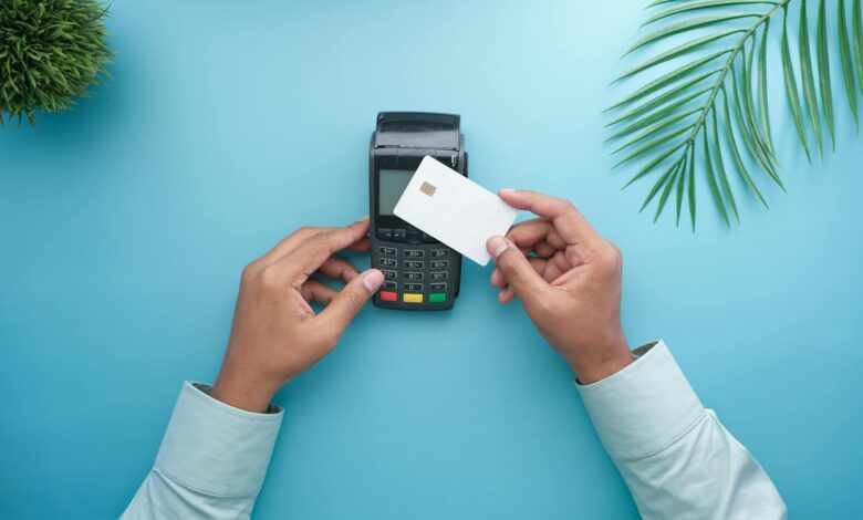 Person using credit card at payment terminal in retail store