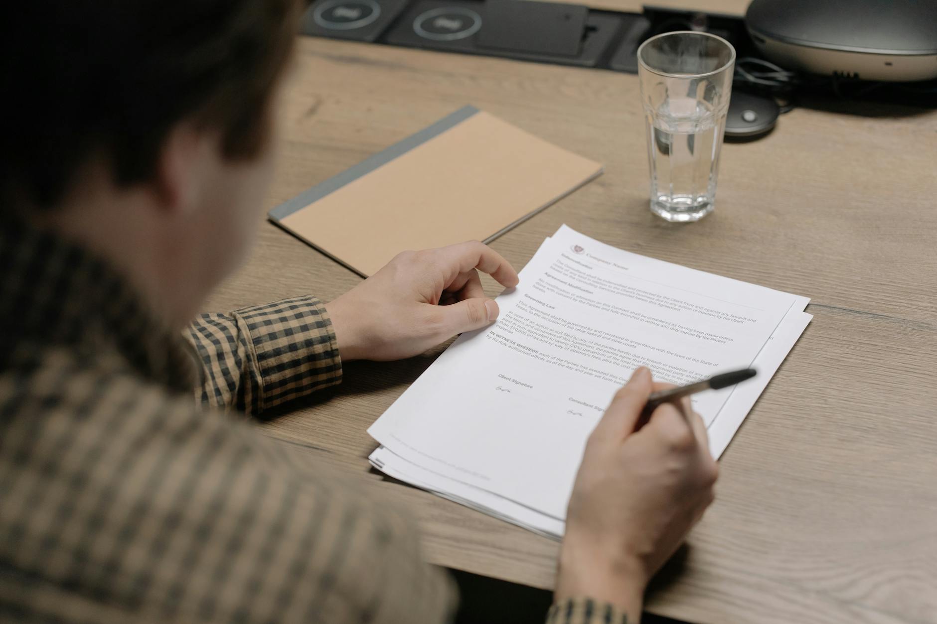 Legal documents and pen on a desk representing estate planning and trust formation