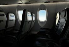 Premium economy airplane cabin interior showing comfortable seating with extra legroom