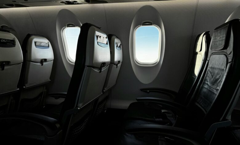 Premium economy airplane cabin interior showing comfortable seating with extra legroom