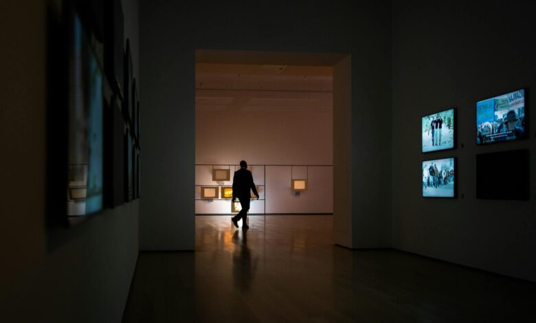 Modern art gallery with large paintings displayed on white walls representing high-value art collections used as collateral