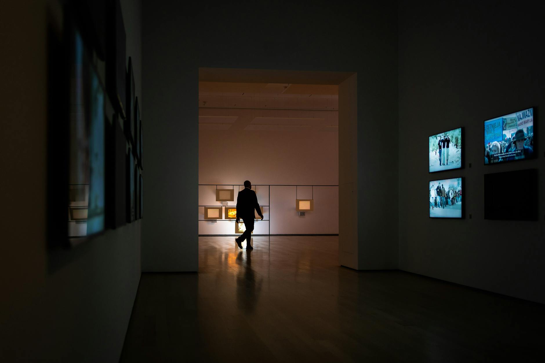Modern art gallery with large paintings displayed on white walls representing high-value art collections used as collateral
