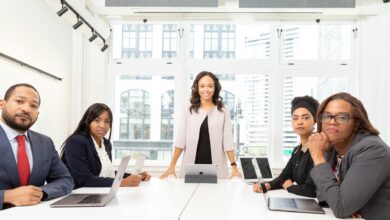 Professional business meeting with executives discussing documents around conference table