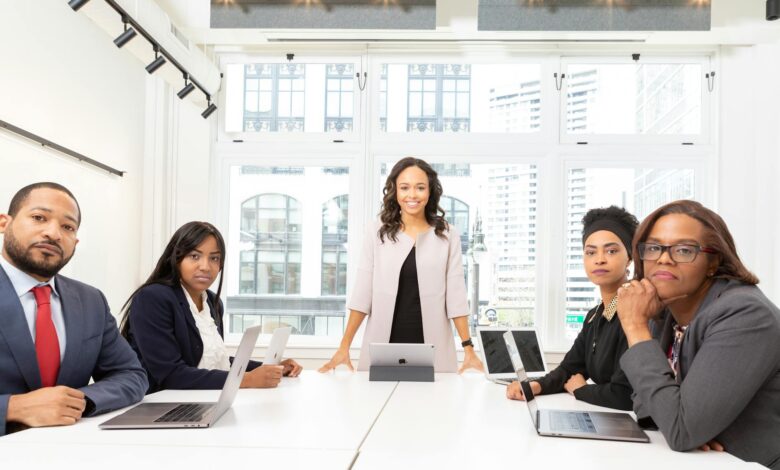 Professional business meeting with executives discussing documents around conference table