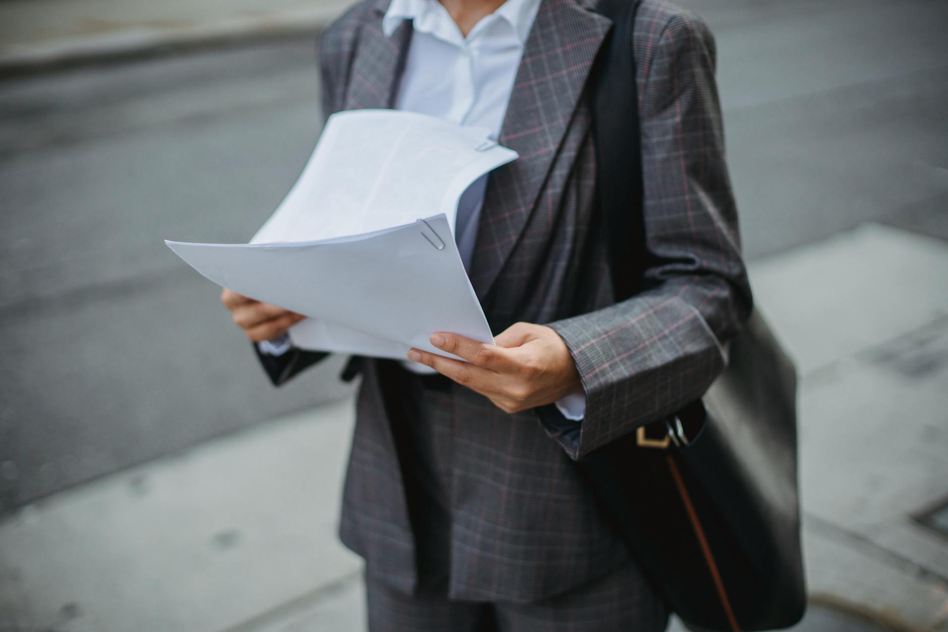 Investor reviewing financial documents and fund performance reports at a desk